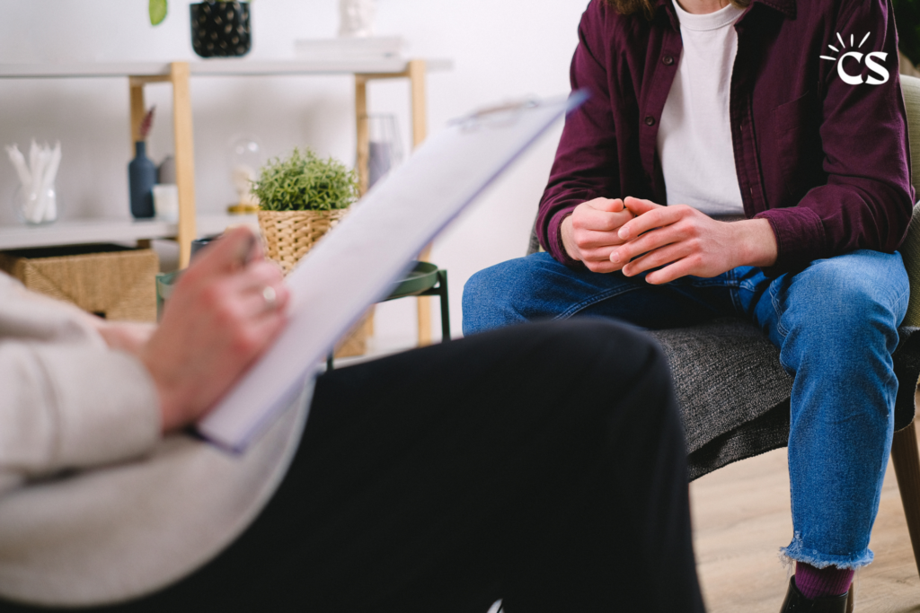 young man sitting talking to a therapist.
